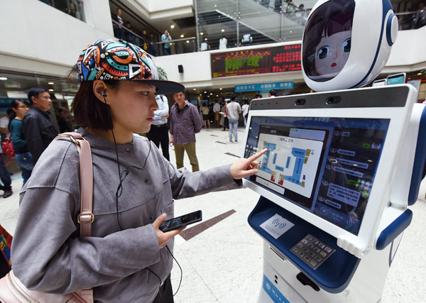 A Hangzhou resident operates a medical service robot at the outpatient lobby of a local hospital. LONG WEI / FOR CHINA DAILY A Hangzhou resident operates a medical service robot at the outpatient lobby of a local hospital. LONG WEI / FOR CHINA DAILY
