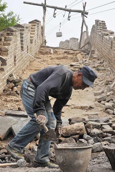 A section of the Great Wall in Beijing is renovated in May. Wu Jiang / For China Daily