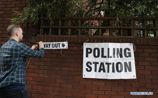 A staff works outside a polling station in London, Britain on June 8, 2017. Polling stations across the Britain opened early Thursday as voters started to make their decision in the general election. (Xinhua/Han Yan) A staff works outside a polling station in London, Britain on June 8, 2017. Polling stations across the Britain opened early Thursday as voters started to make their decision in the general election. (Xinhua/Han Yan)