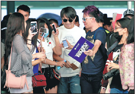 Dimash Kudaibergenov, a popular Kazakh singer, is surrounded by Chinese fans taking photos of him at Guangzhou Baiyun International Airport in Guangdong province last month. Provided Tochina Daily Dimash Kudaibergenov, a popular Kazakh singer, is surrounded by Chinese fans taking photos of him at Guangzhou Baiyun International Airport in Guangdong province last month. Provided Tochina Daily
