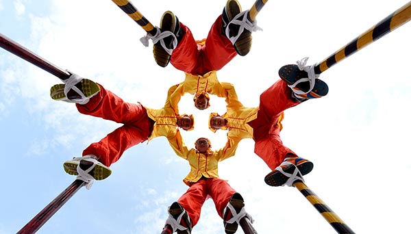 Students in Yiwu, Zhejiang province, perform traditional stilt-walking to celebrate China's first Cultural and Natural Heritage Day on Saturday. Around the nation, activities were held in honor of the day. GONG XIANMING/CHINA DAILY Students in Yiwu, Zhejiang province, perform traditional stilt-walking to celebrate China's first Cultural and Natural Heritage Day on Saturday. Around the nation, activities were held in honor of the day. GONG XIANMING/CHINA DAILY
