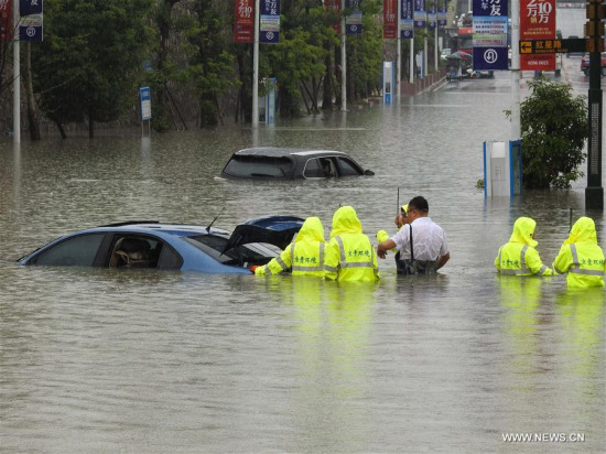 People move a car on a flooded street in Guiyang City, capital of southwest China's Guizhou Province, June 12, 2017. Heavy rain hit Guizhou since Sunday.(Xinhua/Zhang Hui) People move a car on a flooded street in Guiyang City, capital of southwest China's Guizhou Province, June 12, 2017. Heavy rain hit Guizhou since Sunday.(Xinhua/Zhang Hui)