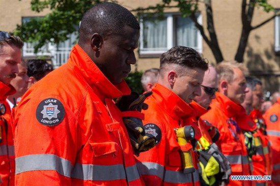 Representatives of the London Fire Brigade and emergency services observe a minute silence outside Notting Hill Methodist Church for the victims of the Grenfell Tower Fire in London, Britain on June 19, 2017. Police said Monday the number of dead or missing in the London Grenfell Tower fire has increased to 79. (Xinhua/Ray Tang) Representatives of the London Fire Brigade and emergency services observe a minute silence outside Notting Hill Methodist Church for the victims of the Grenfell Tower Fire in London, Britain on June 19, 2017. Police said Monday the number of dead or missing in the London Grenfell Tower fire has increased to 79. (Xinhua/Ray Tang)