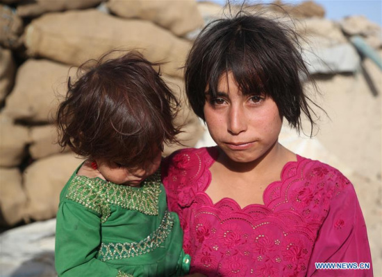 An Afghan displaced child holds her baby sister in Kabul, Afghanistan, June 20, 2017, the World Refugee Day. (Xinhua/Rahmat Alizadah) An Afghan displaced child holds her baby sister in Kabul, Afghanistan, June 20, 2017, the World Refugee Day. (Xinhua/Rahmat Alizadah)
