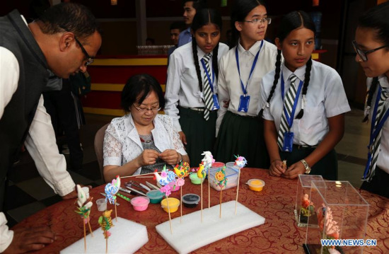 Nepali people visit a stall during the opening of China Intangible Cultural Heritage Week in Kathmandu, Nepal, June 22, 2017. (Xinhua/Sunil Sharma) Nepali people visit a stall during the opening of China Intangible Cultural Heritage Week in Kathmandu, Nepal, June 22, 2017. (Xinhua/Sunil Sharma)