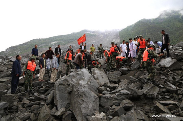 Rescuers work at the accident site after a landslide occurred in Xinmo Village of Maoxian County, Tibetan and Qiang Autonomous Prefecture, southwest China's Sichuan Province, June 24, 2017. The landslide on Saturday morning smashed some 40 homes, where about 100 people are feared to be buried. (Xinhua/He Qinghai) Rescuers work at the accident site after a landslide occurred in Xinmo Village of Maoxian County, Tibetan and Qiang Autonomous Prefecture, southwest China's Sichuan Province, June 24, 2017. The landslide on Saturday morning smashed some 40 homes, where about 100 people are feared to be buried. (Xinhua/He Qinghai)