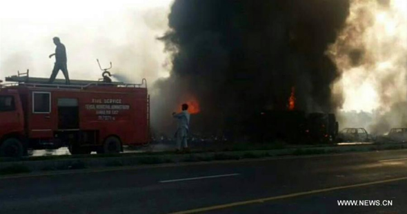 Photo taken on June 25, 2017 with a mobile phone shows fire raging from the accident site in east Pakistan's Baahawalpur. At least 123 people were killed and over 100 others injured in an oil tanker fire that broke out Sunday morning, said rescue officials and hospital sources. (Xinhua/Stringer)