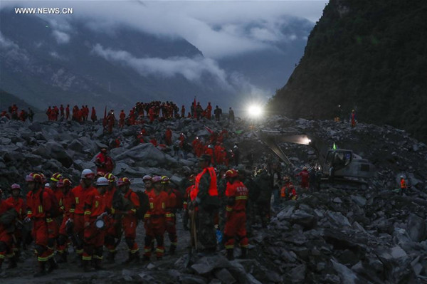 Rescuers work at the accident site after a landslide occurred in Xinmo Village of Maoxian County, Tibetan and Qiang Autonomous Prefecture of Aba, southwest China's Sichuan Province, June 24, 2017. Fifteen people have been confirmed dead in the landslide in Sichuan early Saturday that buried more than 120 people from 62 homes. (Xinhua/Jiang Hongjing) Rescuers work at the accident site after a landslide occurred in Xinmo Village of Maoxian County, Tibetan and Qiang Autonomous Prefecture of Aba, southwest China's Sichuan Province, June 24, 2017. Fifteen people have been confirmed dead in the landslide in Sichuan early Saturday that buried more than 120 people from 62 homes. (Xinhua/Jiang Hongjing)