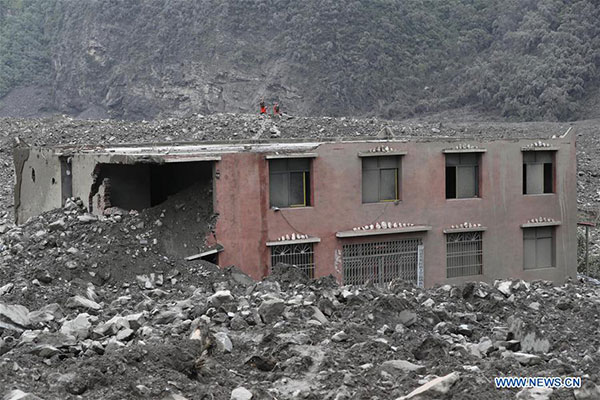 Rescuers work at the accident site after a landslide occurred in Xinmo village of Maoxian county, Tibetan and Qiang autonomous prefecture of Aba, Southwest China's Sichuan province, June 24, 2017. The rescue headquarters of the landslide in Sichuan province has said the landslide buried 62 homes, and more than 120 people are thought to be missing. Currently, more than 1,000 workers with life-detection instruments are engaged in the search for survivors. (Photo/Xinhua) Rescuers work at the accident site after a landslide occurred in Xinmo village of Maoxian county, Tibetan and Qiang autonomous prefecture of Aba, Southwest China's Sichuan province, June 24, 2017. The rescue headquarters of the landslide in Sichuan province has said the landslide buried 62 homes, and more than 120 people are thought to be missing. Currently, more than 1,000 workers with life-detection instruments are engaged in the search for survivors. (Photo/Xinhua)