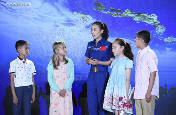 Chinese astronaut Wang Yaping (C) talks with children during an event on the 2017 Global Space Exploration Conference in Beijing, capital of China, June 6, 2017. The conference opened Tuesday in Beijing. (Xinhua/Zhang Ling)