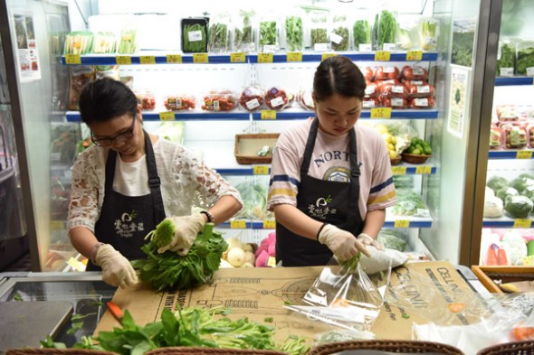 Workers pack vegetables at a store on Centre Street, Hong Kong, in June. (Lyu Xiaowei/Xinhua) Workers pack vegetables at a store on Centre Street, Hong Kong, in June. (Lyu Xiaowei/Xinhua)