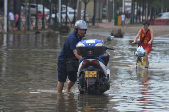 A resident braves waterlog as he travels forward on a flooded road in the urban area of Changsha, capital of central China's Hunan Province, July 5, 2017. (Xinhua/Long Hongtao) A resident braves waterlog as he travels forward on a flooded road in the urban area of Changsha, capital of central China's Hunan Province, July 5, 2017. (Xinhua/Long Hongtao)