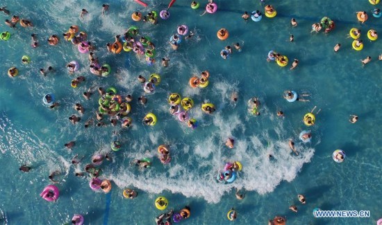Tourists play in the water at a water park in Yangzhou City, east China's Jiangsu Province, July 11, 2017, escaping from the heat of summer. (Xinhua/Meng Delong) Tourists play in the water at a water park in Yangzhou City, east China's Jiangsu Province, July 11, 2017, escaping from the heat of summer. (Xinhua/Meng Delong)