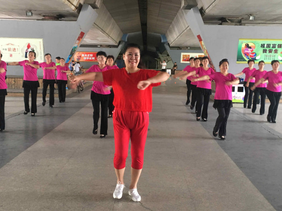 62-year-old Suo Jie dances with her fellow enthusiasts. (CGTN Photo) 62-year-old Suo Jie dances with her fellow enthusiasts. (CGTN Photo)