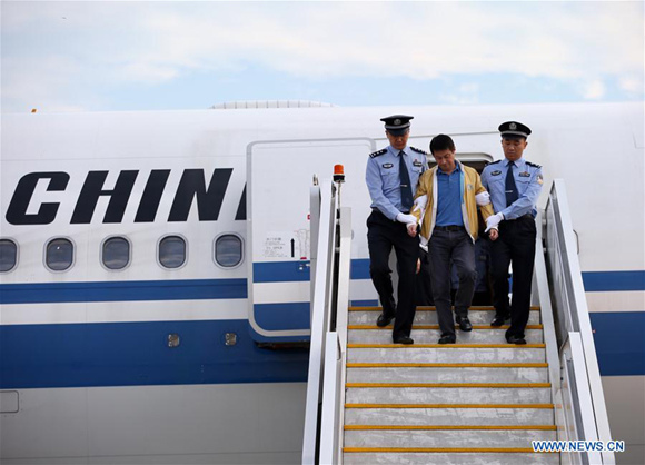 Ren Biao (C), disembarks from a plane under police escort at Beijing Capital International Airport in Beijing, capital of China, July 29, 2017. Ren Biao, one of China's most wanted fugitives, has returned to China and turned himself in to the police, the anti-corruption authority said Saturday. (Xinhua/Jin Liwang) Ren Biao (C), disembarks from a plane under police escort at Beijing Capital International Airport in Beijing, capital of China, July 29, 2017. Ren Biao, one of China's most wanted fugitives, has returned to China and turned himself in to the police, the anti-corruption authority said Saturday. (Xinhua/Jin Liwang)