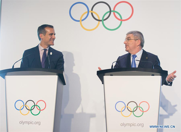 Mayor of Los Angeles Eric Garcetti (L) communicates with International Olympic Committee (IOC) President Thomas Bach at Olympic Museum in Lausanne, Switzerland, July 10, 2017. Members of IOC will hold a session for presentations by the campaign teams for Los Angeles and Paris on July 11th and 12th. (Xinhua file photo/Xu Jinquan) Mayor of Los Angeles Eric Garcetti (L) communicates with International Olympic Committee (IOC) President Thomas Bach at Olympic Museum in Lausanne, Switzerland, July 10, 2017. Members of IOC will hold a session for presentations by the campaign teams for Los Angeles and Paris on July 11th and 12th. (Xinhua file photo/Xu Jinquan)