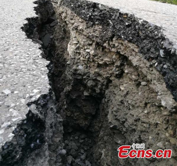 A road is cracked after an earthquake in Jiuzhaigou County, Southwest China’s Sichuan Province, Aug. 9, 2017. At least 13 people were killed and 175 injured after the earthquake jolted Jiuzhaigou County at 9.19pm. (Photo: China News Service/Feng Zheng) A road is cracked after an earthquake in Jiuzhaigou County, Southwest China’s Sichuan Province, Aug. 9, 2017. At least 13 people were killed and 175 injured after the earthquake jolted Jiuzhaigou County at 9.19pm. (Photo: China News Service/Feng Zheng)