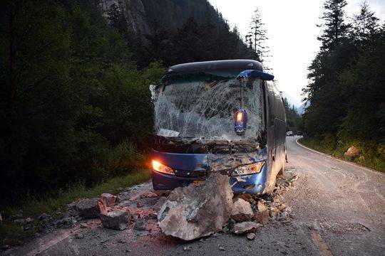 The tourist bus was hit by boulders. (Photo/Xinhua) The tourist bus was hit by boulders. (Photo/Xinhua)