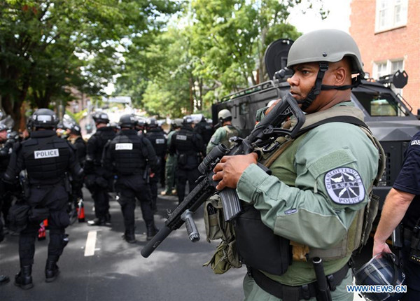 Police stand guard near the rally site in Charlottesville, Virginia, the United States, Aug. 12, 2017. At least one person was killed in a multiple car crash following a violent white nationalist rally on Saturday in Charlottesville in Virginia, Charlottesville Mayor Michael Signer said. (Xinhua/Yin Bogu) Police stand guard near the rally site in Charlottesville, Virginia, the United States, Aug. 12, 2017. At least one person was killed in a multiple car crash following a violent white nationalist rally on Saturday in Charlottesville in Virginia, Charlottesville Mayor Michael Signer said. (Xinhua/Yin Bogu)