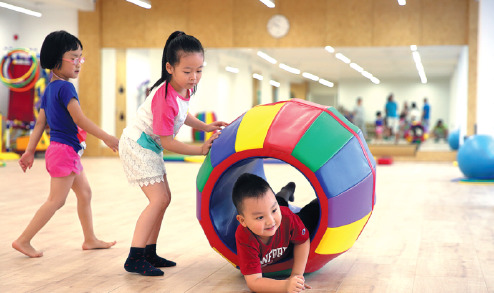 Students play games at a kindergarten in Beijing. Students play games at a kindergarten in Beijing.