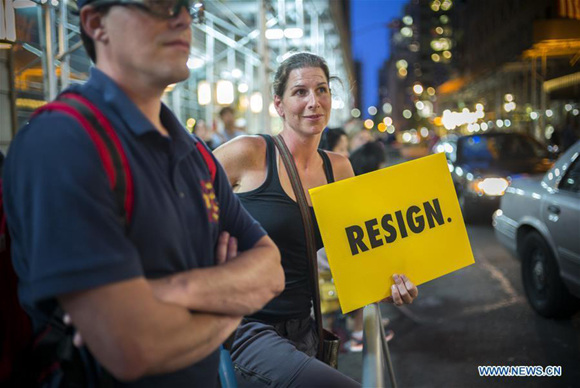 A woman holds a sign during a protest outside the Trump Tower in New York, the United States, Aug. 14, 2017. Thousands of protesters crowded the streets around Trump Tower before U.S. President Donald Trump's first visit to the building since taking office on Monday. (Xinhua/Li Muzi) A woman holds a sign during a protest outside the Trump Tower in New York, the United States, Aug. 14, 2017. Thousands of protesters crowded the streets around Trump Tower before U.S. President Donald Trump's first visit to the building since taking office on Monday. (Xinhua/Li Muzi)