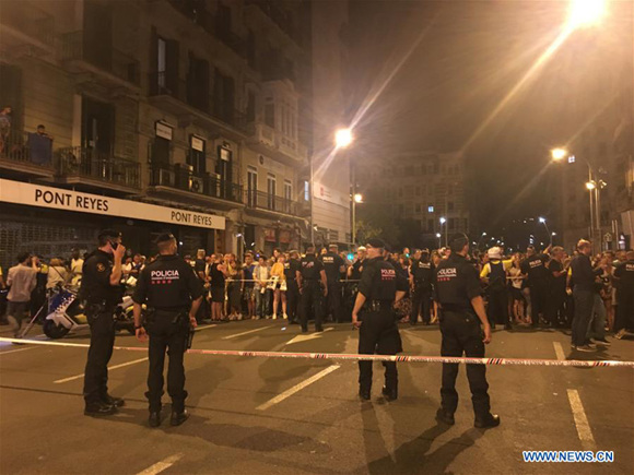 Police cordon off a nearby street following a terrorist attack in central Barcelona, Spain, on Aug. 18, 2017. Thirteen people were confirmed dead and more than 100 others injured, with some of them in very serious condition in Barcelona terror attack on Thursday afternoon, a Spanish official said. (Xinhua/Ying Qiang) Police cordon off a nearby street following a terrorist attack in central Barcelona, Spain, on Aug. 18, 2017. Thirteen people were confirmed dead and more than 100 others injured, with some of them in very serious condition in Barcelona terror attack on Thursday afternoon, a Spanish official said. (Xinhua/Ying Qiang)