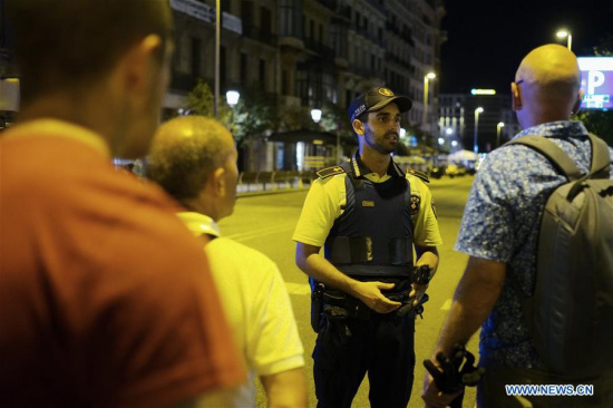 A security staff talks to pedestrians following a terrorist attack in central Barcelona, Spain, on Aug. 17, 2017. Thirteen people were confirmed dead and more than 100 others injured, with some of them in very serious condition in Barcelona terror attack on Thursday afternoon, a Spanish official said. (Xinhua/Han Chong) A security staff talks to pedestrians following a terrorist attack in central Barcelona, Spain, on Aug. 17, 2017. Thirteen people were confirmed dead and more than 100 others injured, with some of them in very serious condition in Barcelona terror attack on Thursday afternoon, a Spanish official said. (Xinhua/Han Chong)