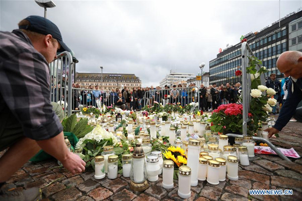 People place candles and flowers to commemorate the victims of Friday's stabbings at the Turku Market Square, Finland on Aug. 19, 2017. Another four Moroccans were detained and a warrant has been issued for a fifth after a young man stabbed people at the squares in the southwestern Finnish city of Turku, police said on Saturday. (Xinhua/Zhang Xuan) People place candles and flowers to commemorate the victims of Friday's stabbings at the Turku Market Square, Finland on Aug. 19, 2017. Another four Moroccans were detained and a warrant has been issued for a fifth after a young man stabbed people at the squares in the southwestern Finnish city of Turku, police said on Saturday. (Xinhua/Zhang Xuan)