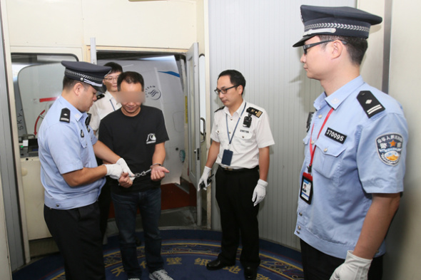 Ji Wenhong is detained on suspicion of smuggling luxuries at Xiamen Gaoqi International Airport in Fujian province on Wednesday. Ji was returned to China after Interpol captured him in Indonesia. Ji Wenhong is detained on suspicion of smuggling luxuries at Xiamen Gaoqi International Airport in Fujian province on Wednesday. Ji was returned to China after Interpol captured him in Indonesia.