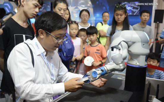 A visitor experiences a bionic arm installation during the World Robot Conference 2017 in Beijing, capital of China, Aug. 24, 2017. During the 5-day event, people came to Beijing Yichuang International Conference and Exhibition Center, experiencing the technology of robot and the possibility of future life. (Xinhua/Li Xin) A visitor experiences a bionic arm installation during the World Robot Conference 2017 in Beijing, capital of China, Aug. 24, 2017. During the 5-day event, people came to Beijing Yichuang International Conference and Exhibition Center, experiencing the technology of robot and the possibility of future life. (Xinhua/Li Xin)