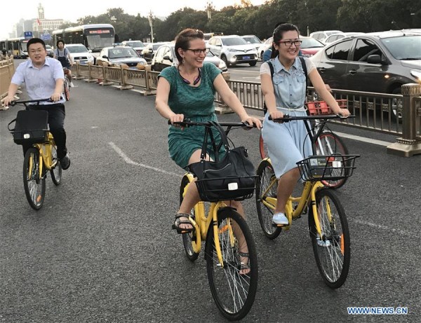 Photo taken by mobile phone shows people riding shared bicycles on Chang'an Avenue in Beijing, capital of China, Aug. 3, 2017. (Xinhua/Luo Xiaoguang) Photo taken by mobile phone shows people riding shared bicycles on Chang'an Avenue in Beijing, capital of China, Aug. 3, 2017. (Xinhua/Luo Xiaoguang)