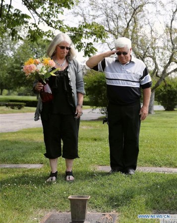 Gail Cooper Baumgartner-Brown (L) and her husband William Brown place a bunch of flowers on the tomb of her father Joseph Cooper in the suburb area of Chicago, the United States, on Aug. 18, 2017. (Xinhua/Wang Ping) Gail Cooper Baumgartner-Brown (L) and her husband William Brown place a bunch of flowers on the tomb of her father Joseph Cooper in the suburb area of Chicago, the United States, on Aug. 18, 2017. (Xinhua/Wang Ping)