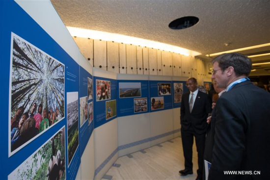 People visit a photo exhibition titled For a Better Life of the People at the Palaise des Nations in Geneva, Switzerland, on Sept. 11, 2017. (Xinhua/Xu Jinquan)
