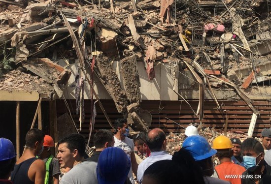 Image taken with a mobile phone shows people watching a collapsed building after an earthquake in Mexico City, capital of Mexico, on Sept. 19, 2017. (Xinhua/Xu Liang) Image taken with a mobile phone shows people watching a collapsed building after an earthquake in Mexico City, capital of Mexico, on Sept. 19, 2017. (Xinhua/Xu Liang)