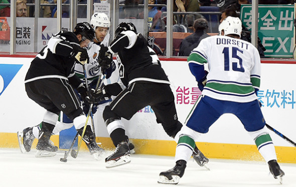 Vancouver Canucks forward Brandon Sutter battles a pair of Los Angeles Kings defenders for puck possession during Thursday's NHL China Games showdown at Mercedes-Benz Arena in Shanghai. The Kings won 5-2, with a rematch set for Saturday afternoon at Wukesong Arena in Beijing. (Photo/China Daily) Vancouver Canucks forward Brandon Sutter battles a pair of Los Angeles Kings defenders for puck possession during Thursday's NHL China Games showdown at Mercedes-Benz Arena in Shanghai. The Kings won 5-2, with a rematch set for Saturday afternoon at Wukesong Arena in Beijing. (Photo/China Daily)