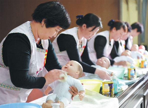 Maternity nurses participate in a baby care competition in Qinyang, Henan province, in April last year. Li Yafeng / For China Daily Maternity nurses participate in a baby care competition in Qinyang, Henan province, in April last year. Li Yafeng / For China Daily