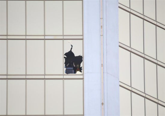 An investigator is seen from one of the broken windows of Mandalay Bay Resort in Las Vegas, the United States, Oct. 4, 2017. (Xinhua/Wang Ying) An investigator is seen from one of the broken windows of Mandalay Bay Resort in Las Vegas, the United States, Oct. 4, 2017. (Xinhua/Wang Ying)