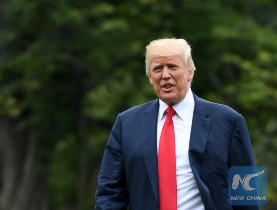 File Photo: U.S. President Donald Trump walks to his office from Marine One as he returns to the White House in Washington D.C., the United States, on Aug. 14, 2017. (Xinhua/Yin Bogu)