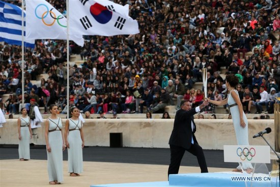 Greek actress Katerina Lehou (1st R) in the role of an Ancient Greek High Priestess passes the Sacred Olympic Flame to Hellenic Olympic Committee President Spyros Capralos at Panathenaic stadium in Athens on Oct. 31, 2017, during the handover ceremony of the Olympic flame for the 2018 Winter Olympics in Pyeongchang, South Korea.(Xinhua/Marios Lolos) Greek actress Katerina Lehou (1st R) in the role of an Ancient Greek High Priestess passes the Sacred Olympic Flame to Hellenic Olympic Committee President Spyros Capralos at Panathenaic stadium in Athens on Oct. 31, 2017, during the handover ceremony of the Olympic flame for the 2018 Winter Olympics in Pyeongchang, South Korea.(Xinhua/Marios Lolos)