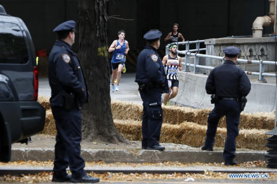 Policemen stand guard as runners participate in the New York City Marathon in Manhattan of New York, the United States, on Nov. 5, 2017. The New York City Marathon was held Sunday with heavy police presence as the massive event through the city was just days after a terrorist attack in Manhattan that killed eight people. (Xinhua/Li Muzi) Policemen stand guard as runners participate in the New York City Marathon in Manhattan of New York, the United States, on Nov. 5, 2017. The New York City Marathon was held Sunday with heavy police presence as the massive event through the city was just days after a terrorist attack in Manhattan that killed eight people. (Xinhua/Li Muzi)