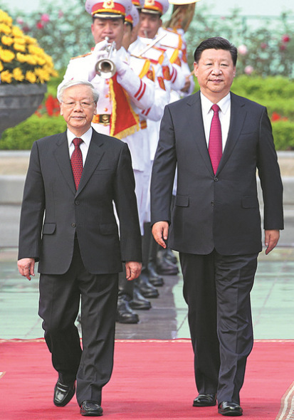 Xi Jinping, general secretary of the Communist Party of China Central Committee, walks with Nguyen Phu Trong, Xi's counterpart in Vietnam's Communist Party, during a welcoming ceremony in Hanoi on Sunday. (FENG YONGBIN / CHINA DAILY) Xi Jinping, general secretary of the Communist Party of China Central Committee, walks with Nguyen Phu Trong, Xi's counterpart in Vietnam's Communist Party, during a welcoming ceremony in Hanoi on Sunday. (FENG YONGBIN / CHINA DAILY)
