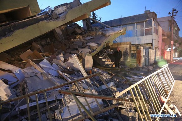 A local resident inspects a collapsed building in the town of Darbandikhan, Sulaimaniyah province, northern Iraq, on Nov. 13, 2017. (Xinhua/Ahmad Halabisaz) A local resident inspects a collapsed building in the town of Darbandikhan, Sulaimaniyah province, northern Iraq, on Nov. 13, 2017. (Xinhua/Ahmad Halabisaz)
