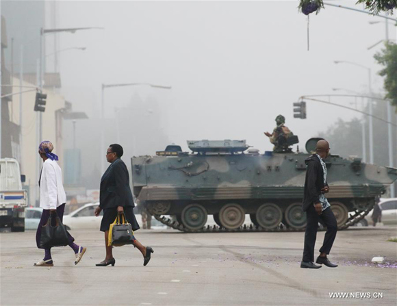 People walk past an armored vehicle on a street in Harare, capital of Zimbabwe, Nov. 15, 2017. (Xinhua/Philimon Bulawayo) People walk past an armored vehicle on a street in Harare, capital of Zimbabwe, Nov. 15, 2017. (Xinhua/Philimon Bulawayo)