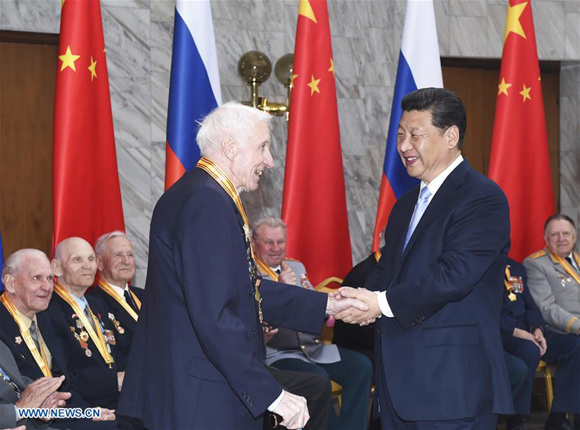 Xi Jinping shakes hands with a Russian veteran in Moscow, Russia, on May 8, 2015. Xi met with 18 representatives of Russian veterans who fought dauntlessly on the battlefield in northeast China during the anti-Japanese war and in Russia's Great Patriotic War in Moscow, May 8. When presenting an award to a Russian veteran, Xi saw the difficulty the old soldier had in moving and said at once, Let me come over to you. You can stay there. (Xinhua/Zhang Duo)