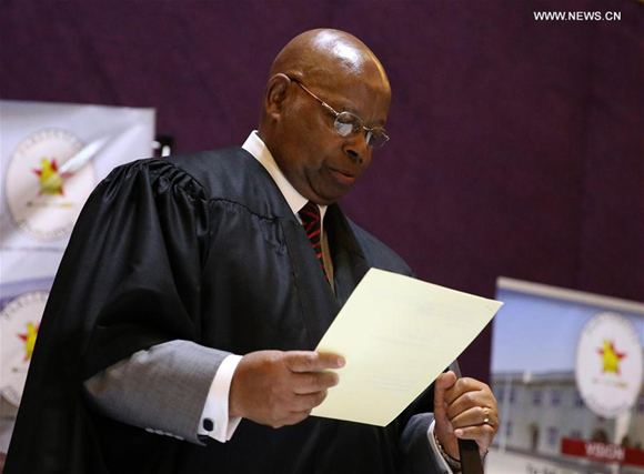 Zimbabwean Speaker of Parliament Jacob Mudenda reads the resignation letter of President Robert Mugabe in Harare, capital of Zimbabwe, on Nov. 21, 2017. Zimbabwean President Robert Mugabe has resigned. His resignation was announced Tuesday by Speaker of Parliament Jacob Mudenda during a joint sitting of Senate and National Assembly that was debating his impeachment motion. (Xinhua/Shaun Jusa) Zimbabwean Speaker of Parliament Jacob Mudenda reads the resignation letter of President Robert Mugabe in Harare, capital of Zimbabwe, on Nov. 21, 2017. Zimbabwean President Robert Mugabe has resigned. His resignation was announced Tuesday by Speaker of Parliament Jacob Mudenda during a joint sitting of Senate and National Assembly that was debating his impeachment motion. (Xinhua/Shaun Jusa)
