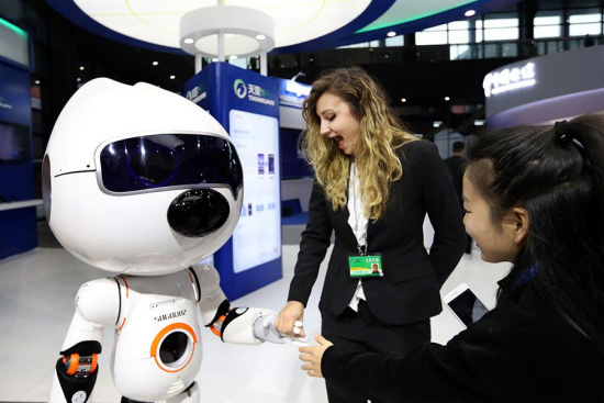 Bermal Kaplan (center) from Turkey interacts with a Sogou intelligent robot during the Light of the Internet Exposition, in Wuzhen, Zhejiang province, Dec 2, 2017. (Photo by Zou Hong / chinadaily.com.cn) Bermal Kaplan (center) from Turkey interacts with a Sogou intelligent robot during the Light of the Internet Exposition, in Wuzhen, Zhejiang province, Dec 2, 2017. (Photo by Zou Hong / chinadaily.com.cn)