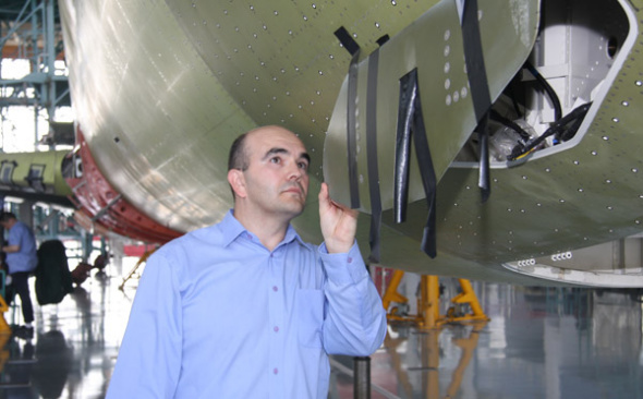 Cyrille Breard, an engineer at the Commercial Aircraft Corporation of China who manages the noise and emission project of C919, China's domestically-made passenger plane, checks the components of a plane in production. (Wang Jiliang / For China Daily) Cyrille Breard, an engineer at the Commercial Aircraft Corporation of China who manages the noise and emission project of C919, China's domestically-made passenger plane, checks the components of a plane in production. (Wang Jiliang / For China Daily)