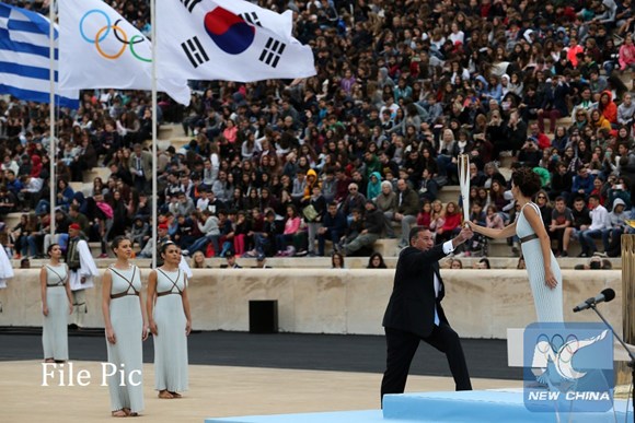 Greek actress Katerina Lehou (1st R) in the role of an Ancient Greek High Priestess passes the Sacred Olympic Flame to Hellenic Olympic Committee President Spyros Capralos at Panathenaic stadium in Athens on Oct. 31, 2017,during the handover ceremony of the Olympic flame for the 2018 Winter Olympics in Pyeongchang, South Korea.(Xinhua/Marios Lolos) Greek actress Katerina Lehou (1st R) in the role of an Ancient Greek High Priestess passes the Sacred Olympic Flame to Hellenic Olympic Committee President Spyros Capralos at Panathenaic stadium in Athens on Oct. 31, 2017,during the handover ceremony of the Olympic flame for the 2018 Winter Olympics in Pyeongchang, South Korea.(Xinhua/Marios Lolos)