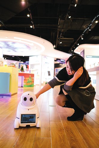A customer interacts with a household robot in a high-tech product store. (Photo: Li Hao/GT) A customer interacts with a household robot in a high-tech product store. (Photo: Li Hao/GT)