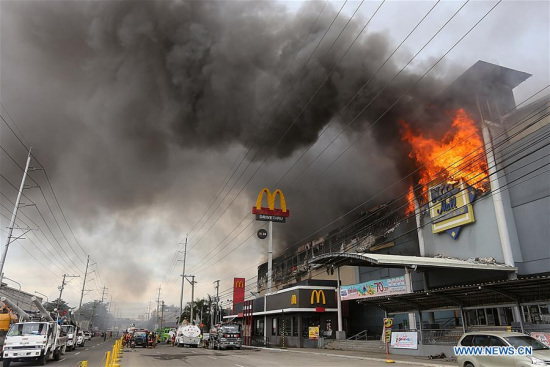 Fire rages at a shopping mall in Davao City, the Philippines, Dec. 24, 2017. At least 37 people may have died in the massive fire that ravaged a shopping mall here on Saturday, authorities said on Sunday. (Xinhua/Stringer) Fire rages at a shopping mall in Davao City, the Philippines, Dec. 24, 2017. At least 37 people may have died in the massive fire that ravaged a shopping mall here on Saturday, authorities said on Sunday. (Xinhua/Stringer)